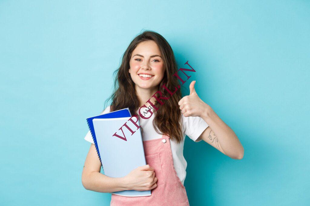 young-woman-attend-courses-girl-student-studying-holding-notebooks-showing-thumb-up-approval-recommending-company-standing-blue-background-scaled-1.jpg